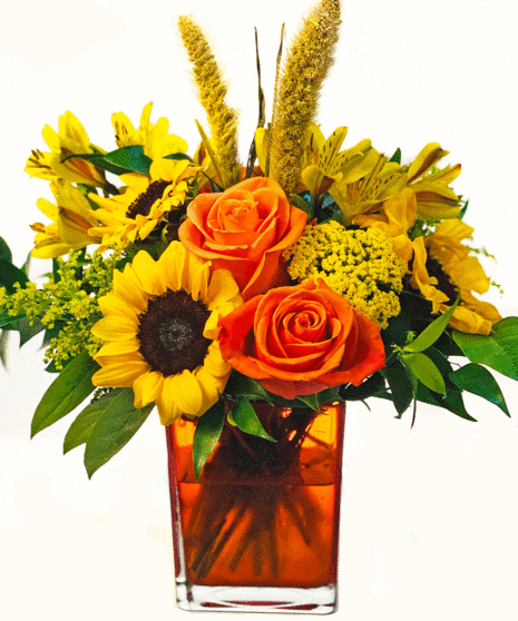 Festive cube arrangement with sunflowers, orange roses, alstroemeria and more
